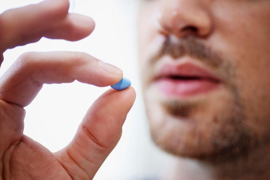 a man takes a pill to stimulate power